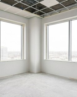 Finished office corner with window returns and drop-ceiling grid