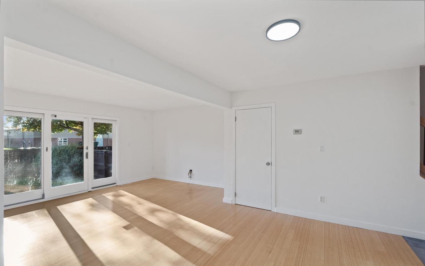 Great room with wood-look plank flooring and fresh paint